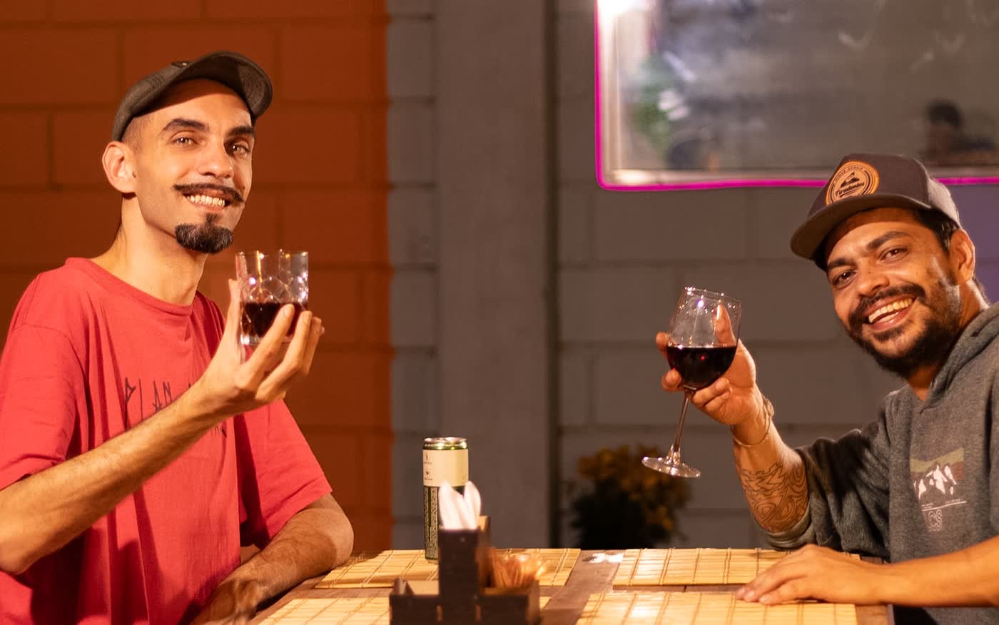 Clientes brindando com vinho em mesa do La Ferve Bar